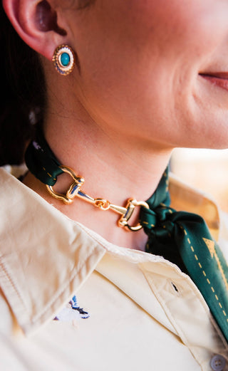 rowdy crowd snaffle bit scarf slide in gold paired with green smiley twilly