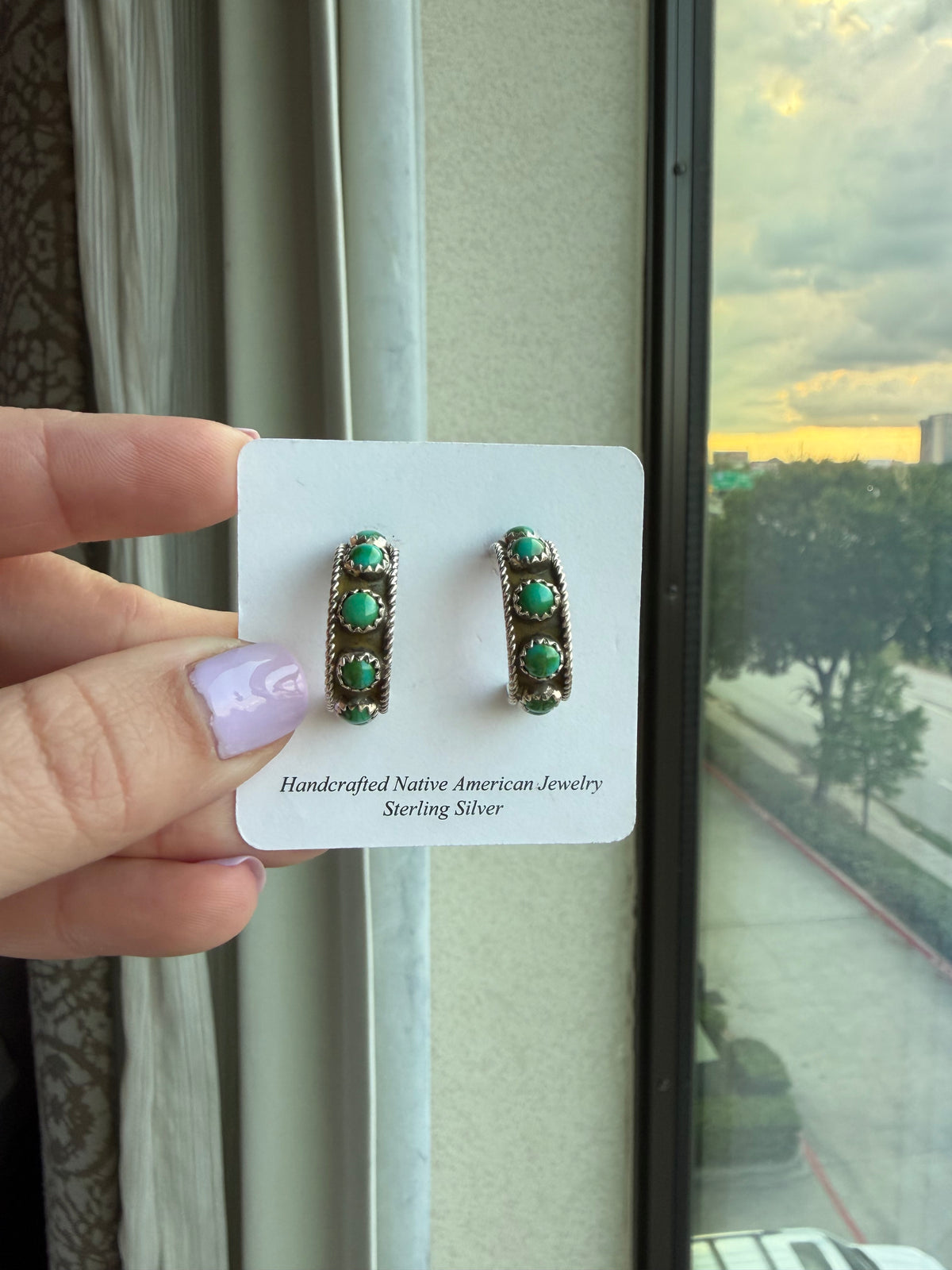 Pair of Sonoran Trail #2 sterling silver hoop earrings on a display card, with round green turquoise stones and rope edges.