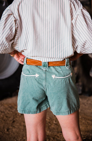 toast suede Western leather belt by double j saddlery with white figure 8 gunslinger stitching styled with teal shorts by howdy hanny