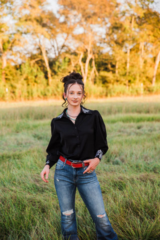 Turquoise Haven Midnight Rider Horse Embroidered Blouse styled with distressed blue jeans and a red belt in a Western outfit.