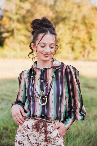 Turquoise Haven Sagebrush Trails Serape Blouse close-up showing green, cream and dark stripes with gathered sleeves and cuffs.