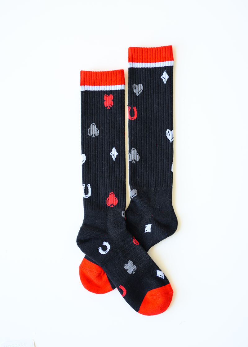 Pair of black socks with red accents and various symbols on a white background