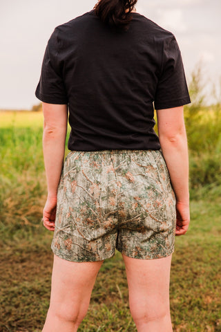 Back view of women’s camo boxer shorts, showing the gathered waistband, relaxed fit and allover woodland camouflage print.