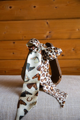 Wild Horses silk twilly by XOXO Art & Co showing brown, black and white horse portraits, horseshoes and contrasting leopard print.